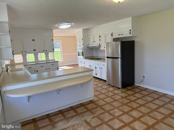 a kitchen with stainless steel appliances a refrigerator and a stove