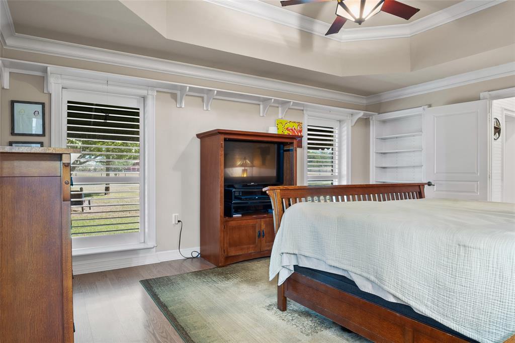 4451 Shiloh Road Midlothian, TX 76065 - Photo 16 of 39 Primary bedroom features plantation shutters and built in shelving.