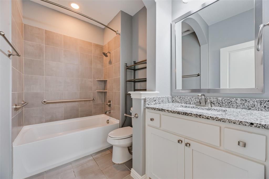 4670 I Rhett Lane, Unit I Carrollton, TX 75010 - Photo 29 of 31 White vanity with a granite countertop, undermount sink, and brushed nickel hardware