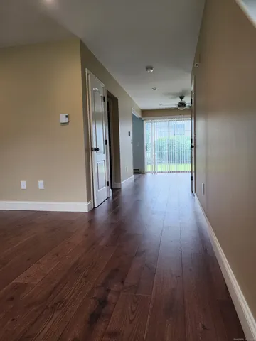 a view of a hallway with wooden floor