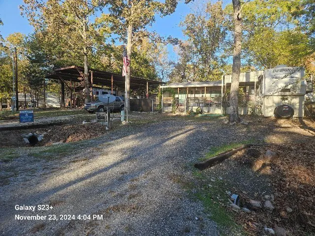 a view of a house with a yard and pathway