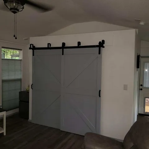 a view of a room with wooden floor