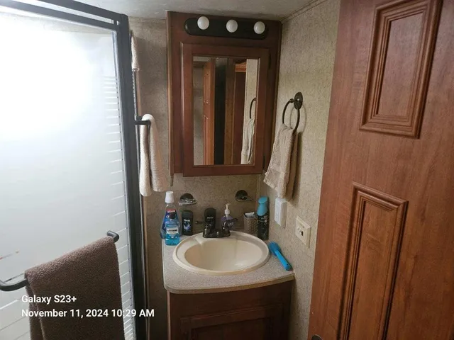 a bathroom with a sink a toilet and a mirror