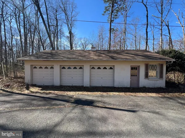 a view of a house with a large tree