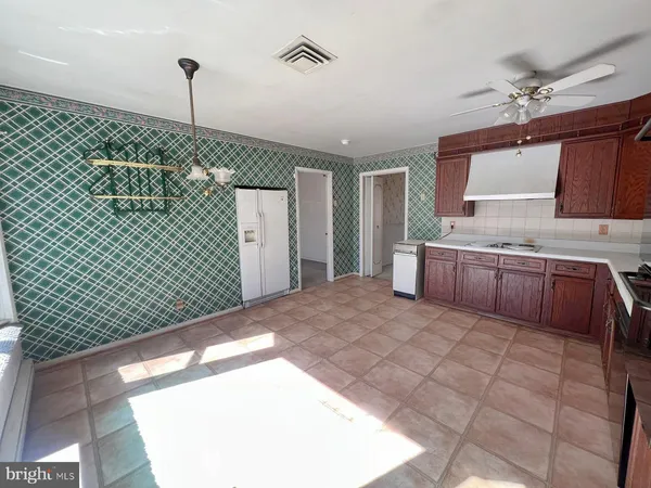 a spacious bedroom with a large bed and a chandelier