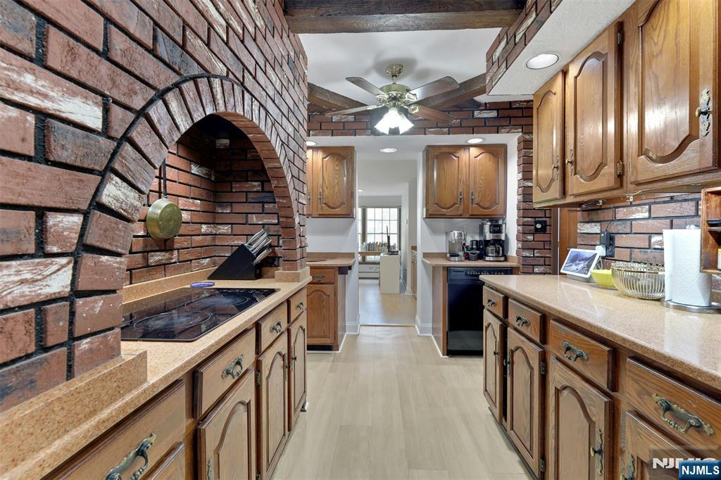 1280 Sussex Road Teaneck, NJ 07666 - Photo 11 of 36 a kitchen with stainless steel appliances granite countertop a sink a stove top oven a chimney and cabinets