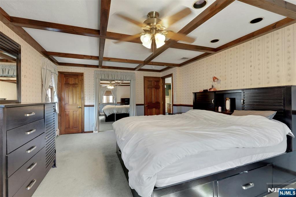 1280 Sussex Road Teaneck, NJ 07666 - Photo 20 of 36 a bedroom with a bed and a chandelier