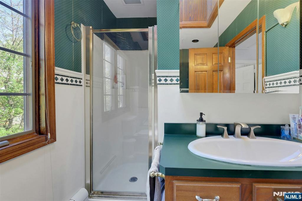 1280 Sussex Road Teaneck, NJ 07666 - Photo 24 of 36 a bathroom with a sink and a mirror