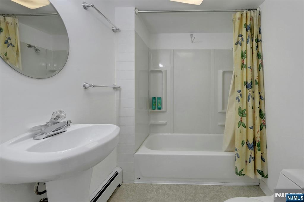 1280 Sussex Road Teaneck, NJ 07666 - Photo 28 of 36 a bathroom with a sink and a mirror