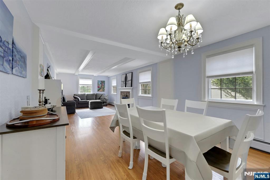 1280 Sussex Road Teaneck, NJ 07666 - Photo 9 of 36 a view of a dining room with furniture a chandelier and wooden floor