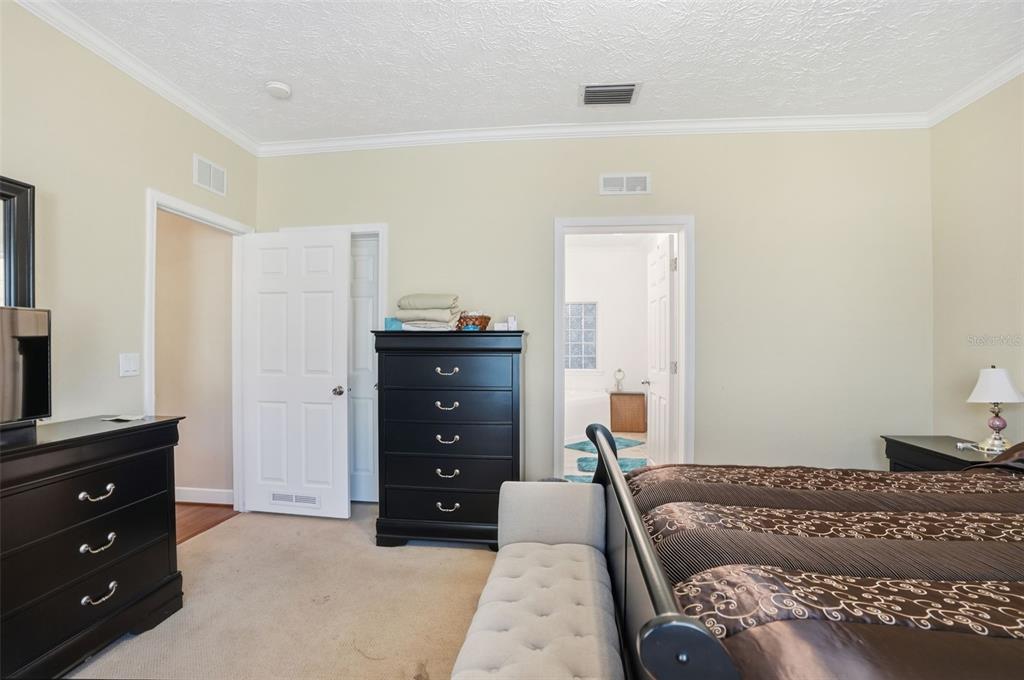 11805 Osprey Avenue Weeki Wachee, FL 34614 - Photo 13 of 34 a bedroom with a bed and a dresser