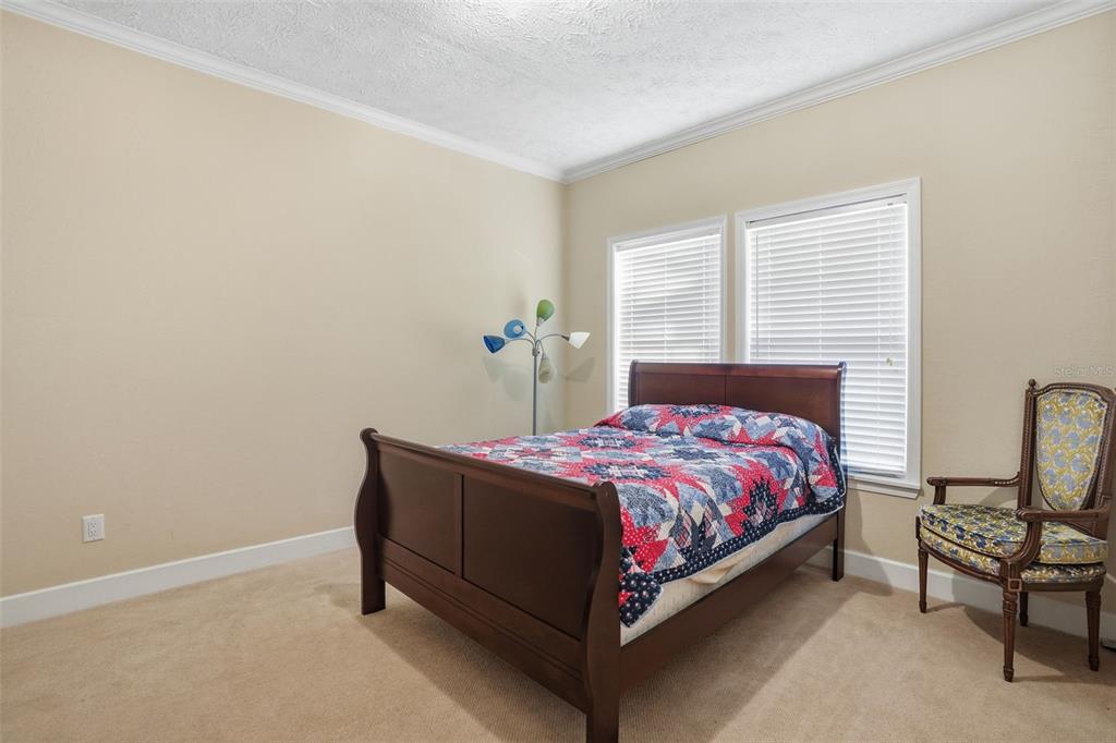 11805 Osprey Avenue Weeki Wachee, FL 34614 - Photo 16 of 34 a bedroom with a bed chair and window