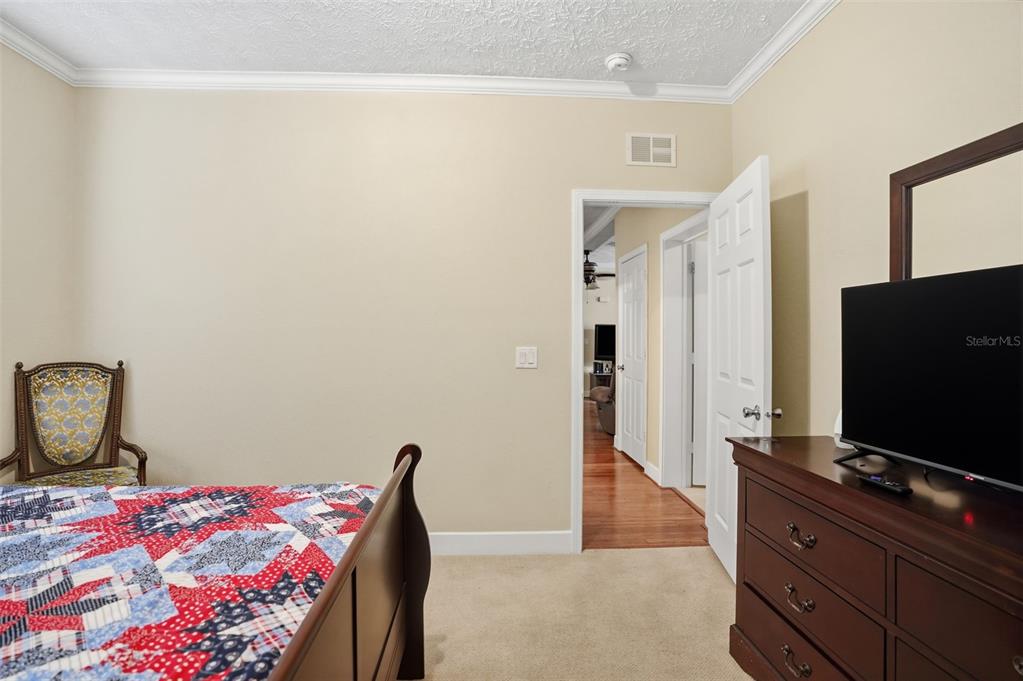 11805 Osprey Avenue Weeki Wachee, FL 34614 - Photo 17 of 34 a living room with a bed and a flat screen tv