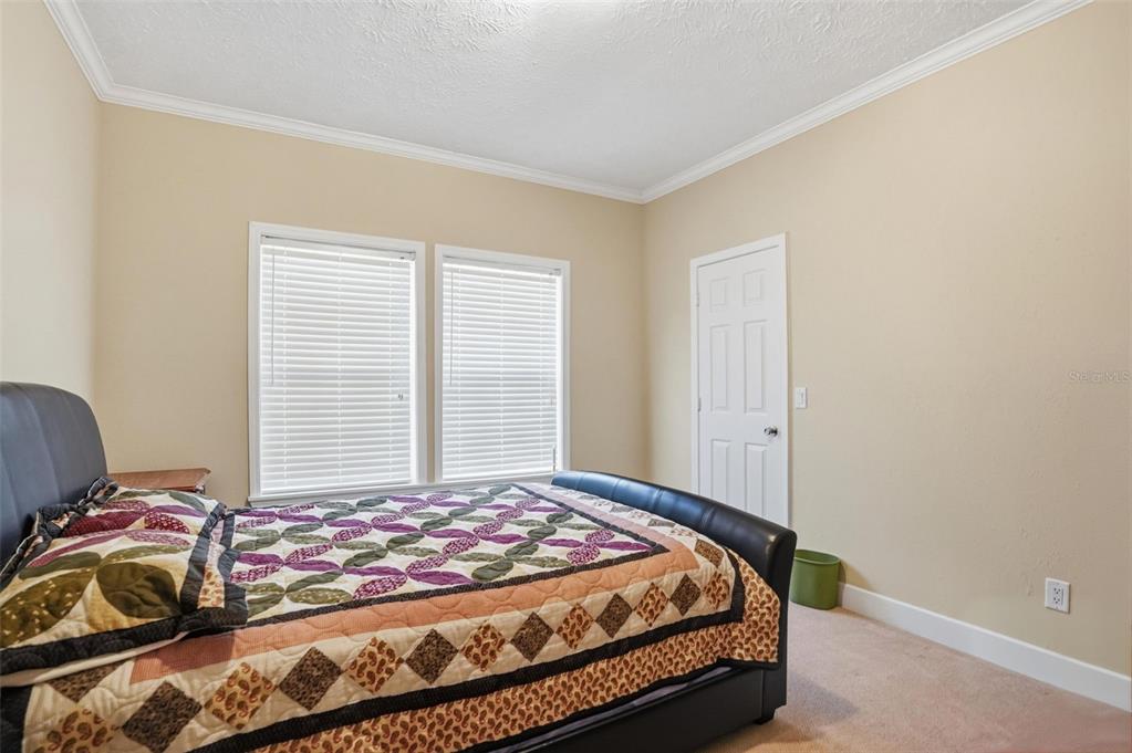 11805 Osprey Avenue Weeki Wachee, FL 34614 - Photo 19 of 34 a bedroom with a bed and a window