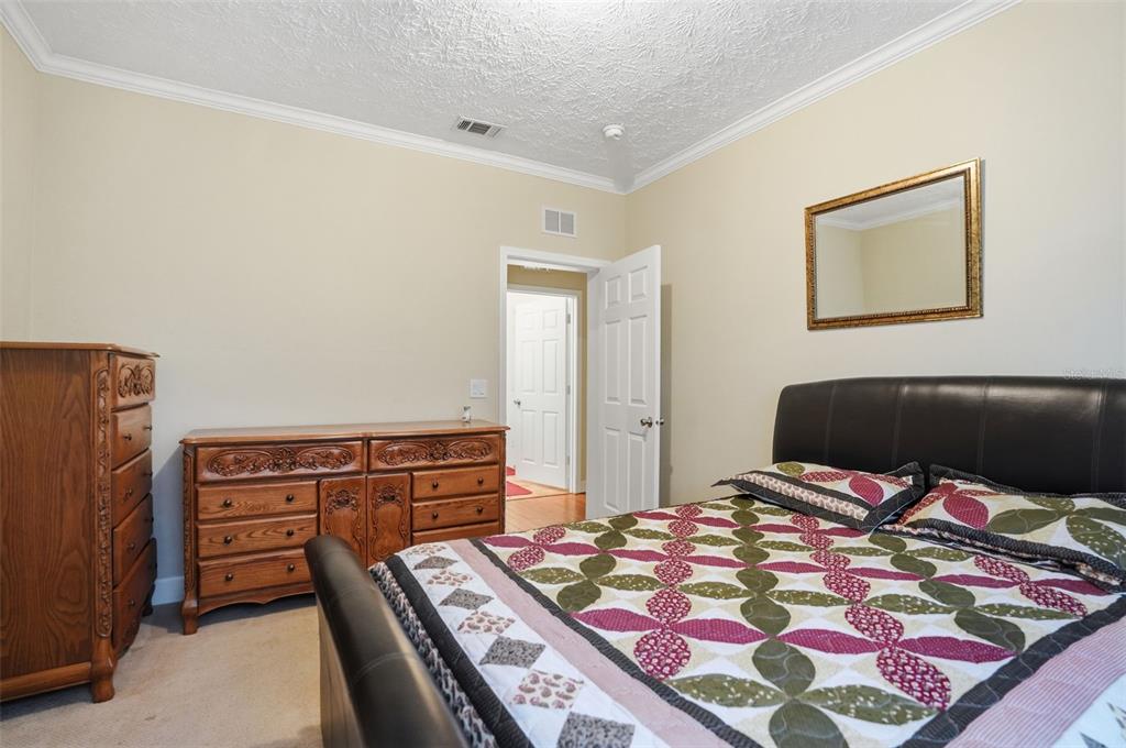 11805 Osprey Avenue Weeki Wachee, FL 34614 - Photo 20 of 34 a bedroom with a bed and a dresser