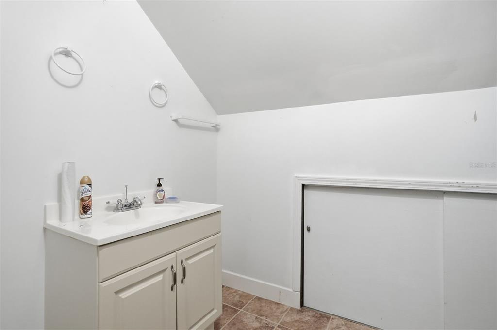 11805 Osprey Avenue Weeki Wachee, FL 34614 - Photo 27 of 34 a bathroom with a sink mirror and vanity