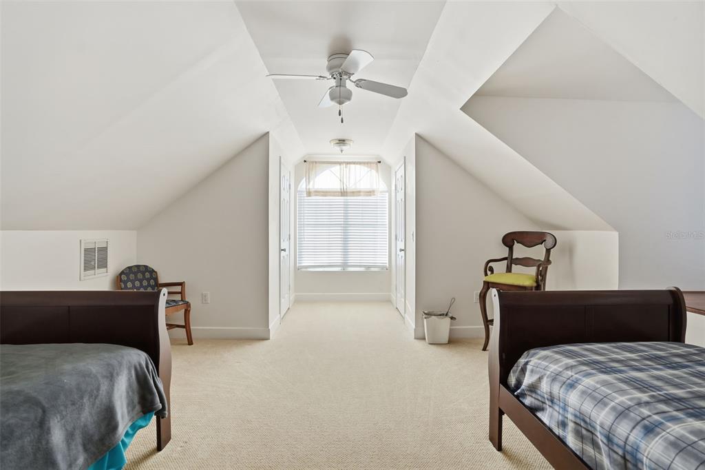 11805 Osprey Avenue Weeki Wachee, FL 34614 - Photo 28 of 34 a bedroom with a bed and a chandelier