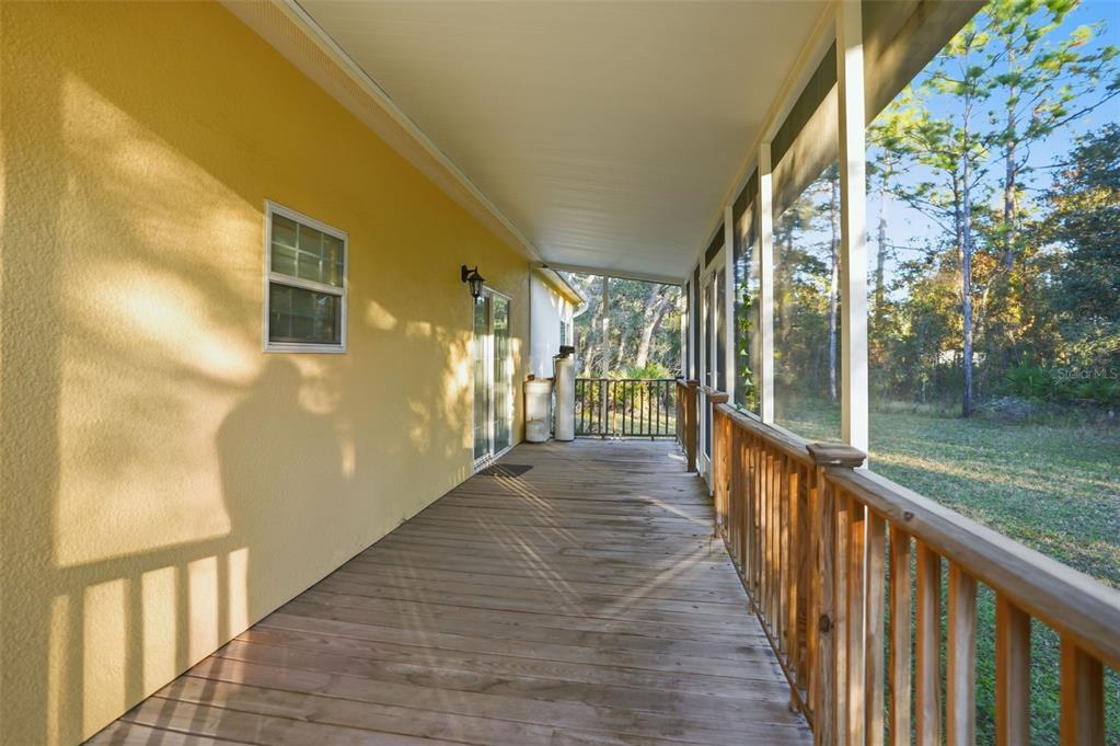 11805 Osprey Avenue Weeki Wachee, FL 34614 - Photo 31 of 34 a view of a porch with wooden floor and stairs
