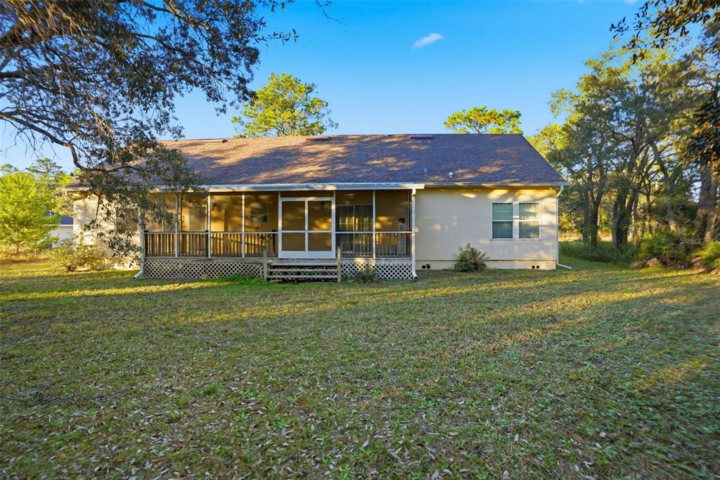 11805 Osprey Avenue Weeki Wachee, FL 34614 - Photo 33 of 34 a front view of a house with a garden