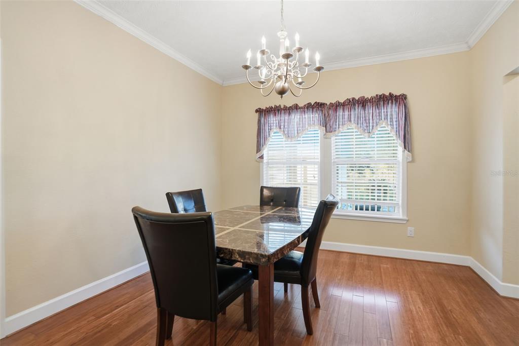 11805 Osprey Avenue Weeki Wachee, FL 34614 - Photo 10 of 34 a view of a dining room with furniture window and wooden floor