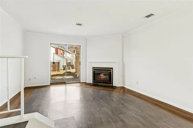a view of a room with wooden floor and white walls