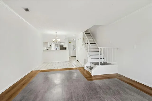 a view of a kitchen with wooden floor and a fireplace