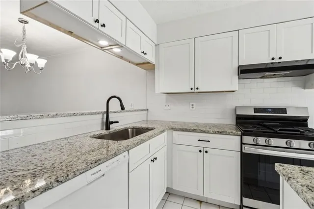 a kitchen with a stove and a refrigerator