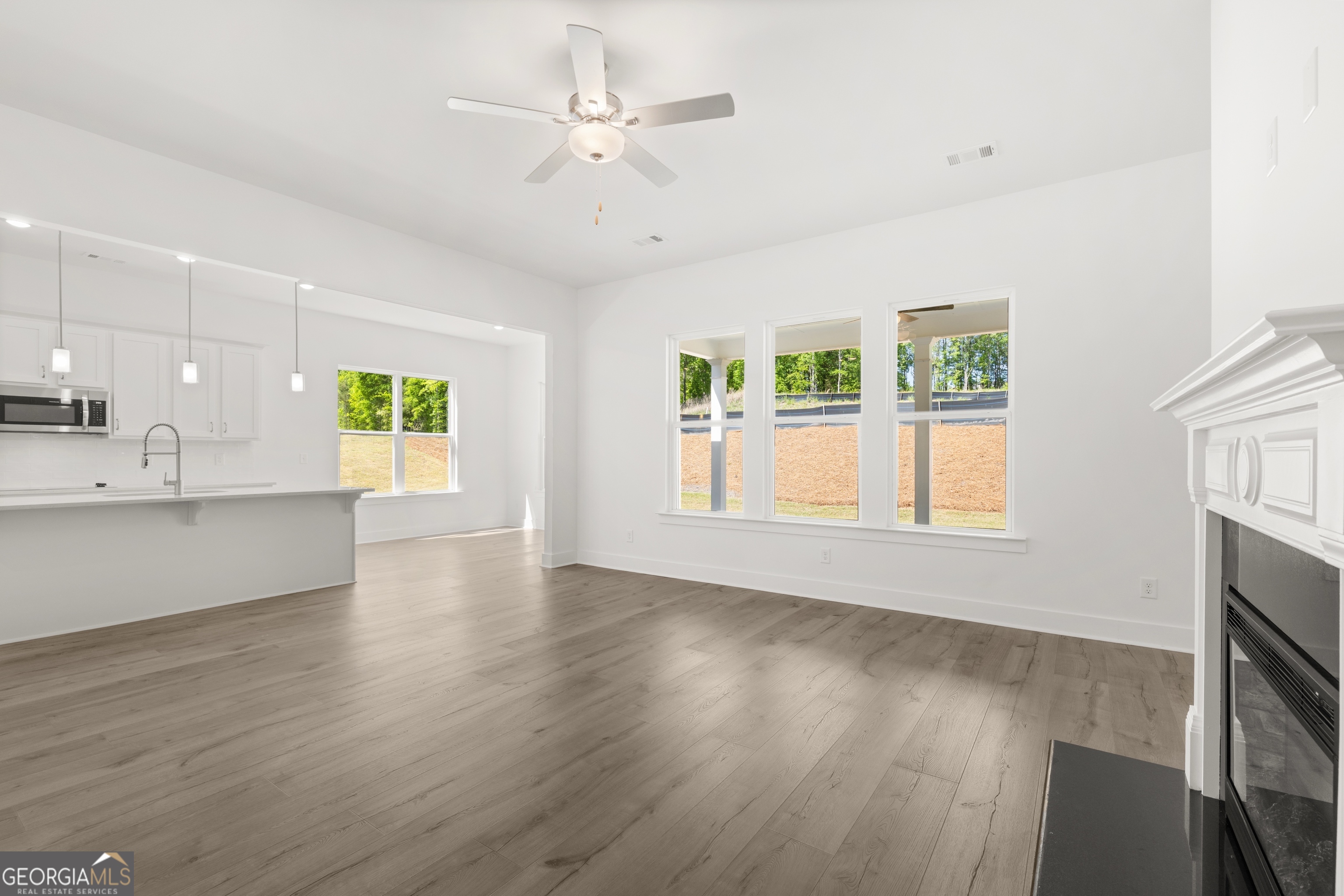 15 Overview Court Hoschton, GA 30548 - Photo 20 of 43 a view of an empty room with a window and wooden floor