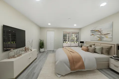 a spacious bedroom with a large bed and a flat screen tv