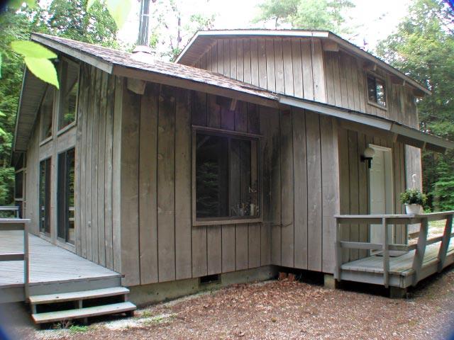 34 Sitting Bull Road Becket, MA 01223 - Photo 1 of 9 a backyard of a house with a garden and barbeque oven