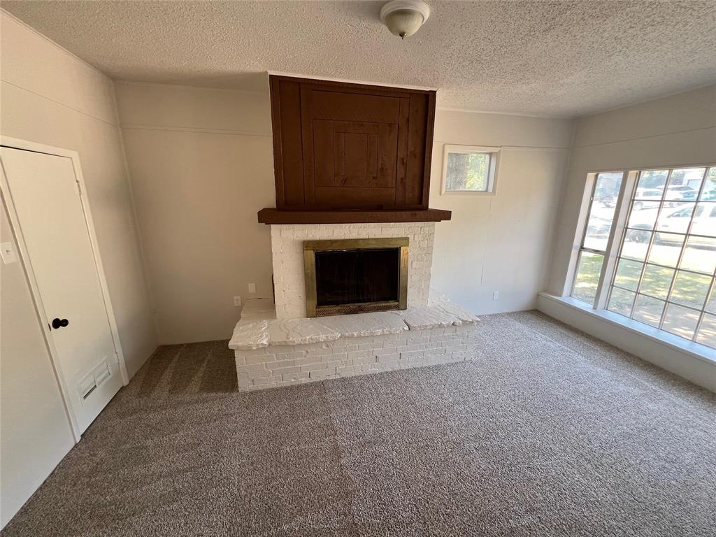 213 Wanda Way Hurst, TX 76053 - Photo 8 of 29 Cozy additional living space with a modernized wood burning fire place