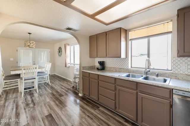 a kitchen with a sink cabinets and window