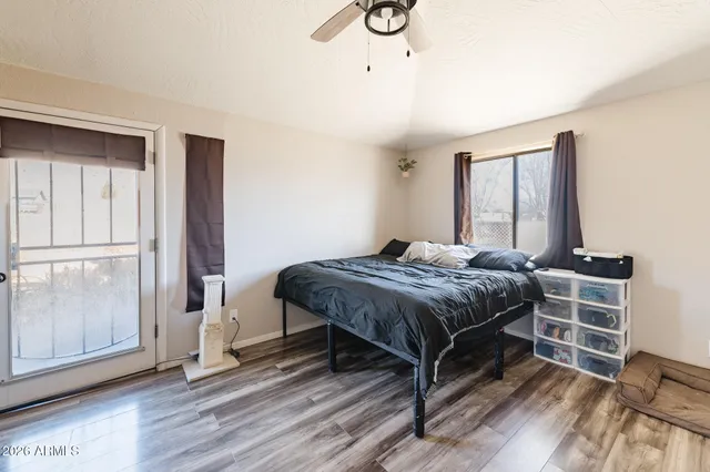 a bedroom with a bed and wooden floor