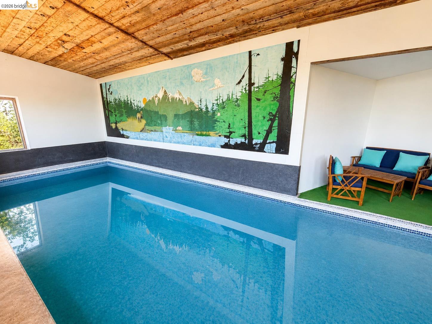 18195 Wards Ferry Road Sonora, CA 95370 - Photo 6 of 67 Indoor swimming pool featuring blue mosaic tiling, a wood plank ceiling, a full-wall mural, and a built-in seating area