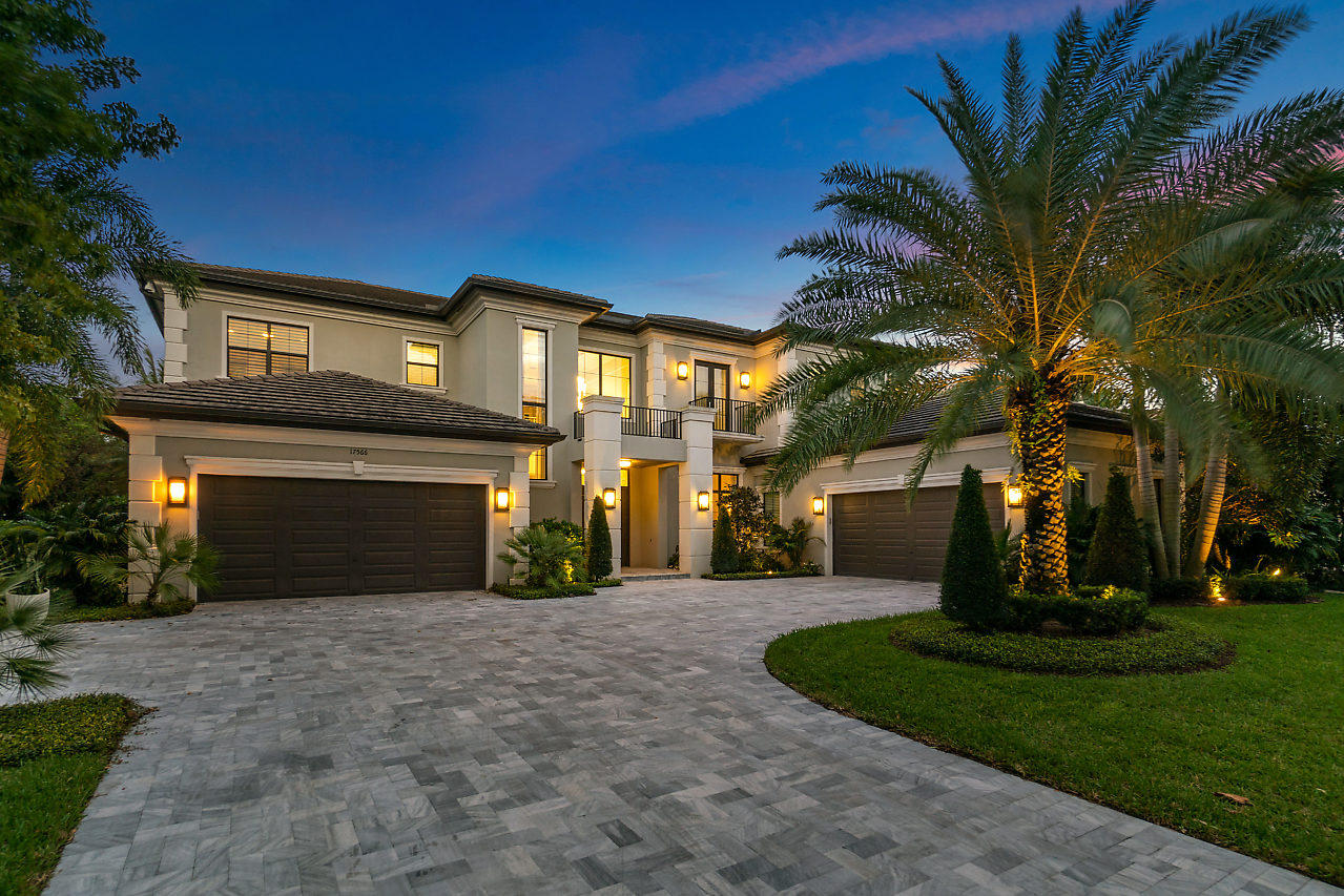 a view of a house with a yard and large tree