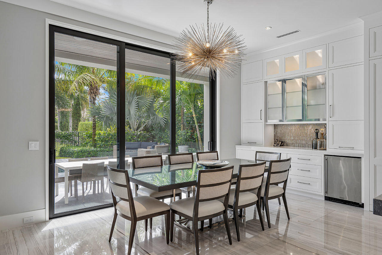 17566 Grand Este Way Boca Raton, FL 33496 - Photo 12 of 116 a dining room with furniture a chandelier and wooden floor