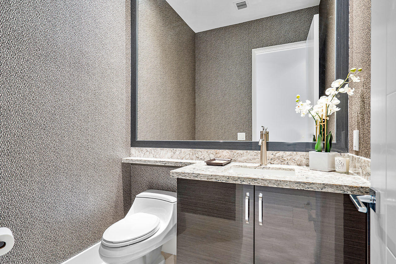 17566 Grand Este Way Boca Raton, FL 33496 - Photo 20 of 116 a bathroom with a granite countertop sink a toilet and a mirror