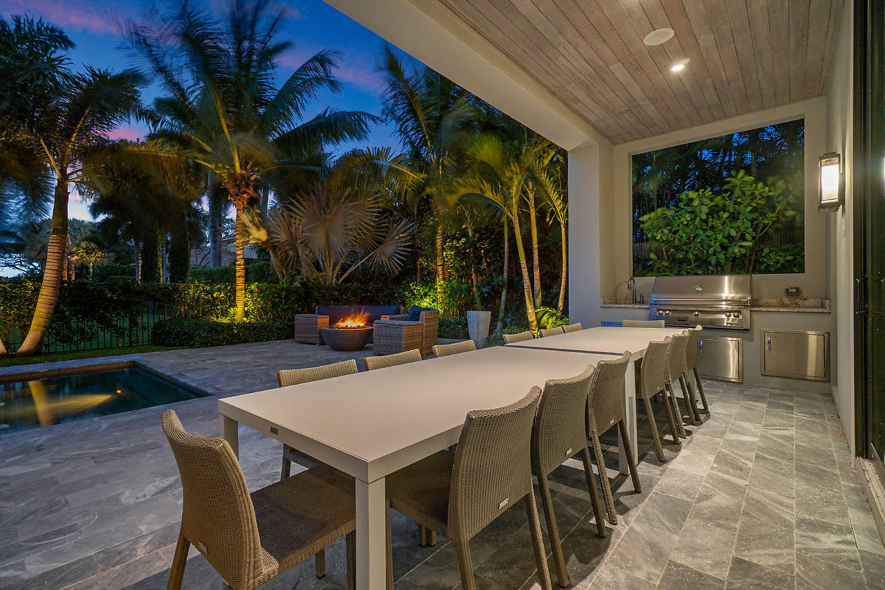 17566 Grand Este Way Boca Raton, FL 33496 - Photo 46 of 116 a view of a patio with table and chairs potted plants and palm trees