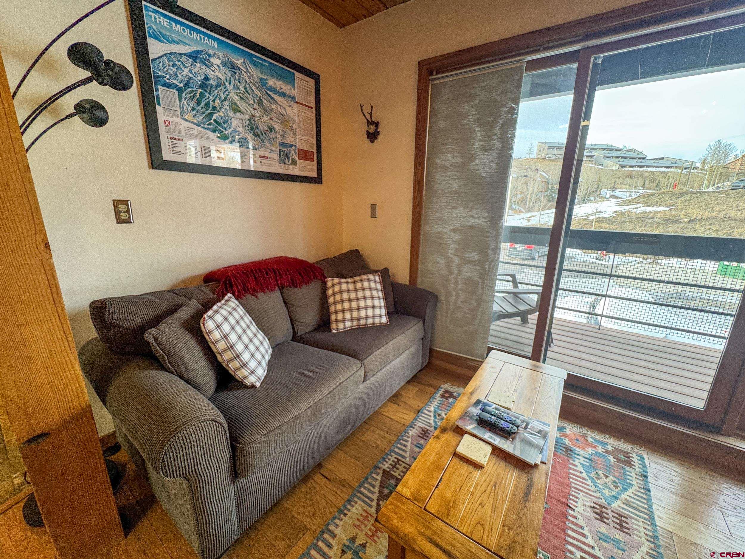 400 Gothic Road, Unit 305 Crested Butte, CO 81225 - Photo 3 of 38 a living room with furniture and a large window