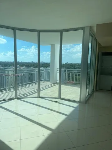 a view of empty room with floor to ceiling windows