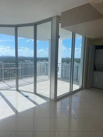 a view of an empty room and window a ceiling fan