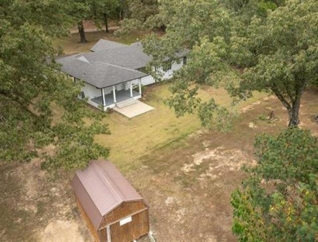 1050 North Reid Hooker Road Eads, TN 38028 - Photo 4 of 4 Ranch-style residence featuring a covered porch with white columns, a gray shingle roof, and a concrete patio
