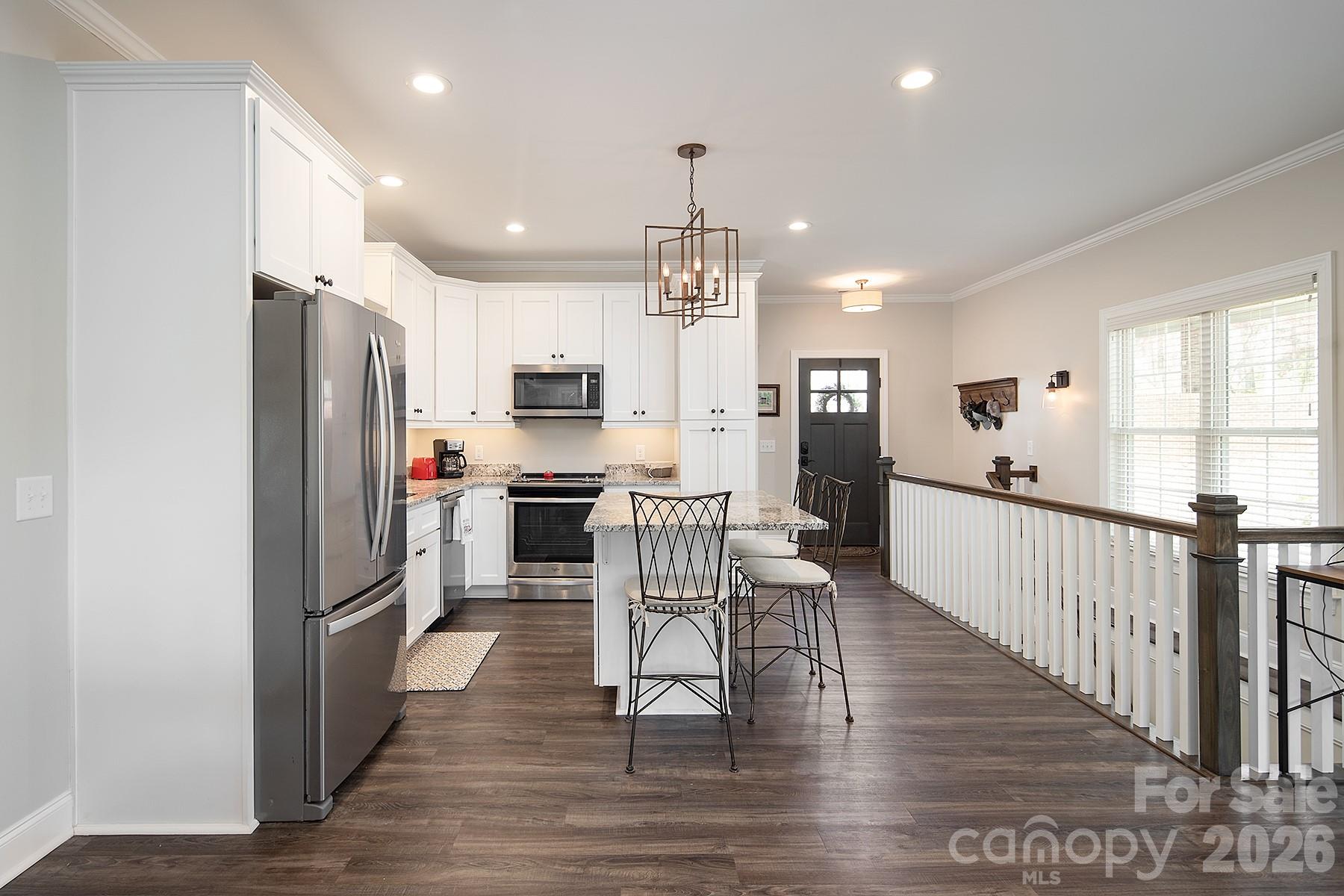 689 Emerald Shores Road Mount Gilead, NC 27306 - Photo 15 of 46 a view of kitchen with refrigerator microwave and wooden floor