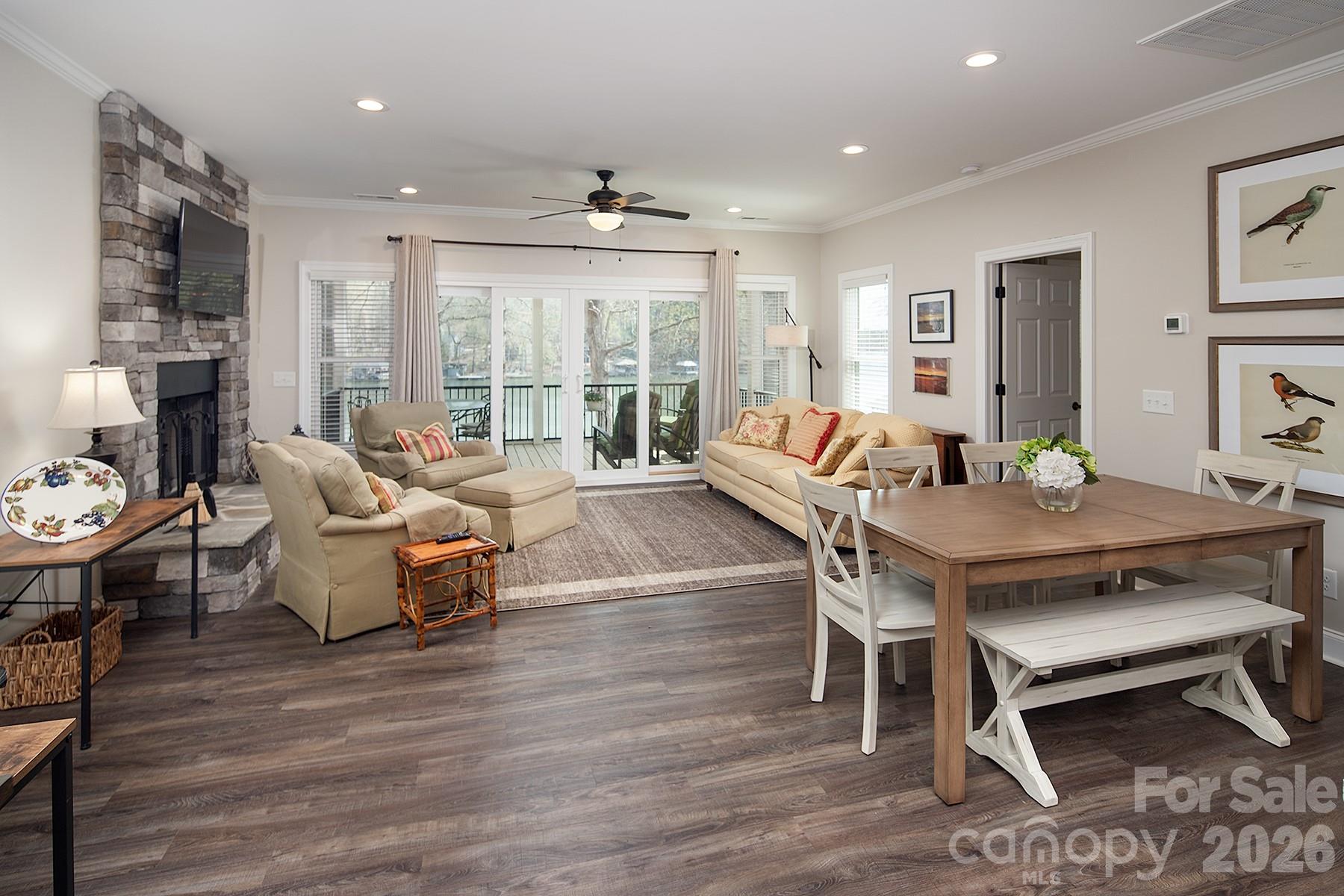 689 Emerald Shores Road Mount Gilead, NC 27306 - Photo 17 of 46 a living room with furniture a table and wooden floor