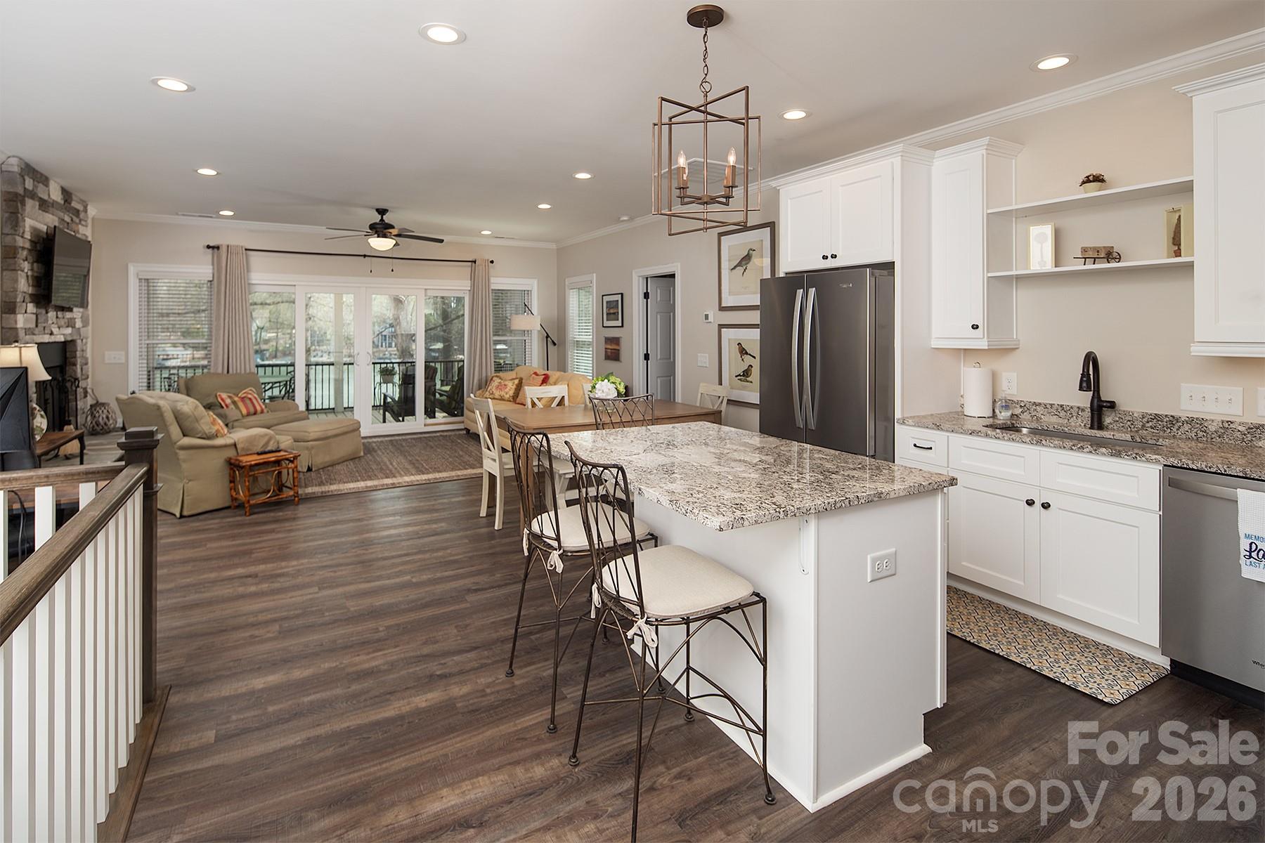 689 Emerald Shores Road Mount Gilead, NC 27306 - Photo 18 of 46 a open kitchen with stainless steel appliances granite countertop a stove and refrigerator a oven with wooden floors