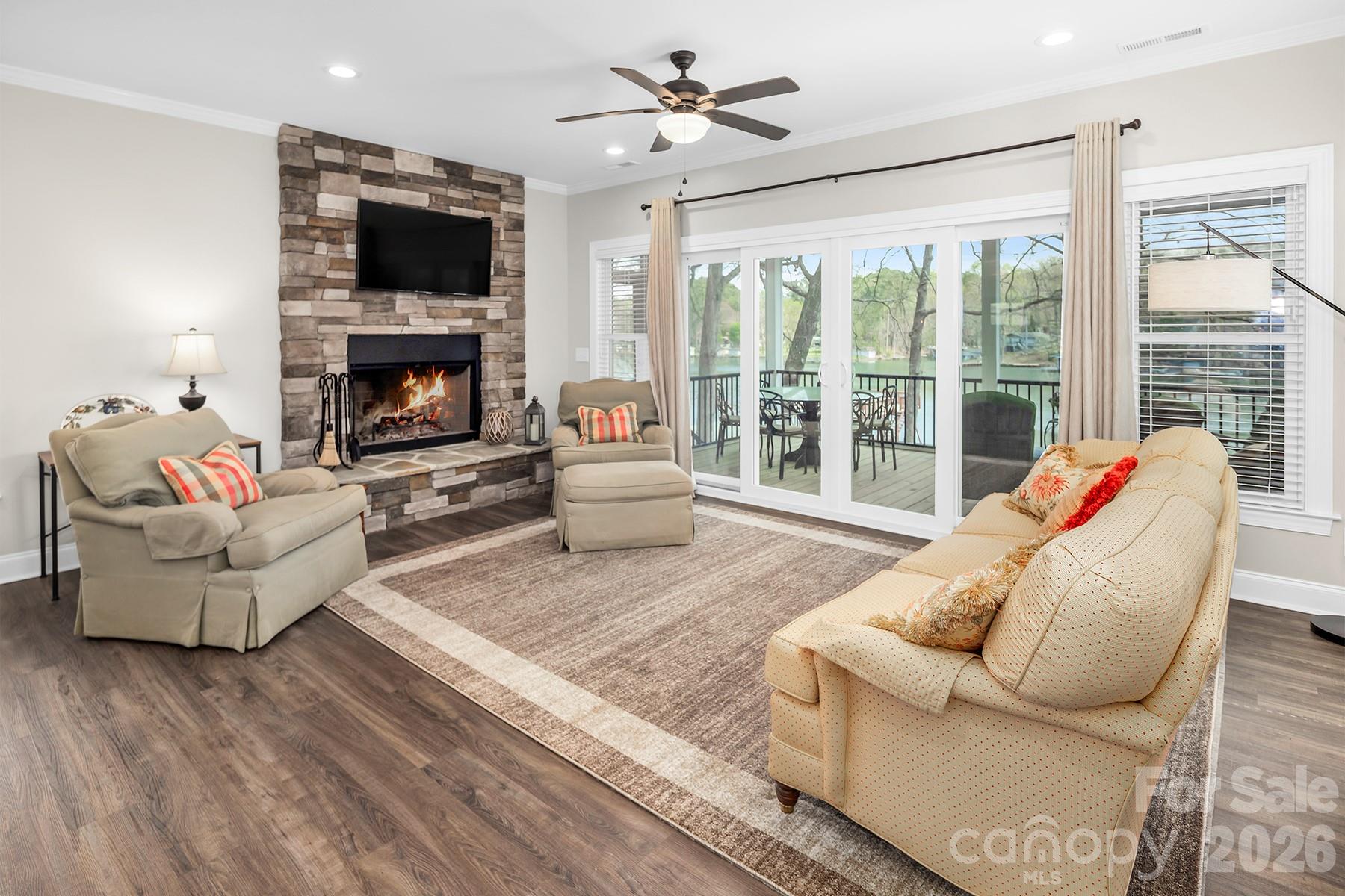 689 Emerald Shores Road Mount Gilead, NC 27306 - Photo 20 of 46 a living room with furniture a flat screen tv and a fireplace