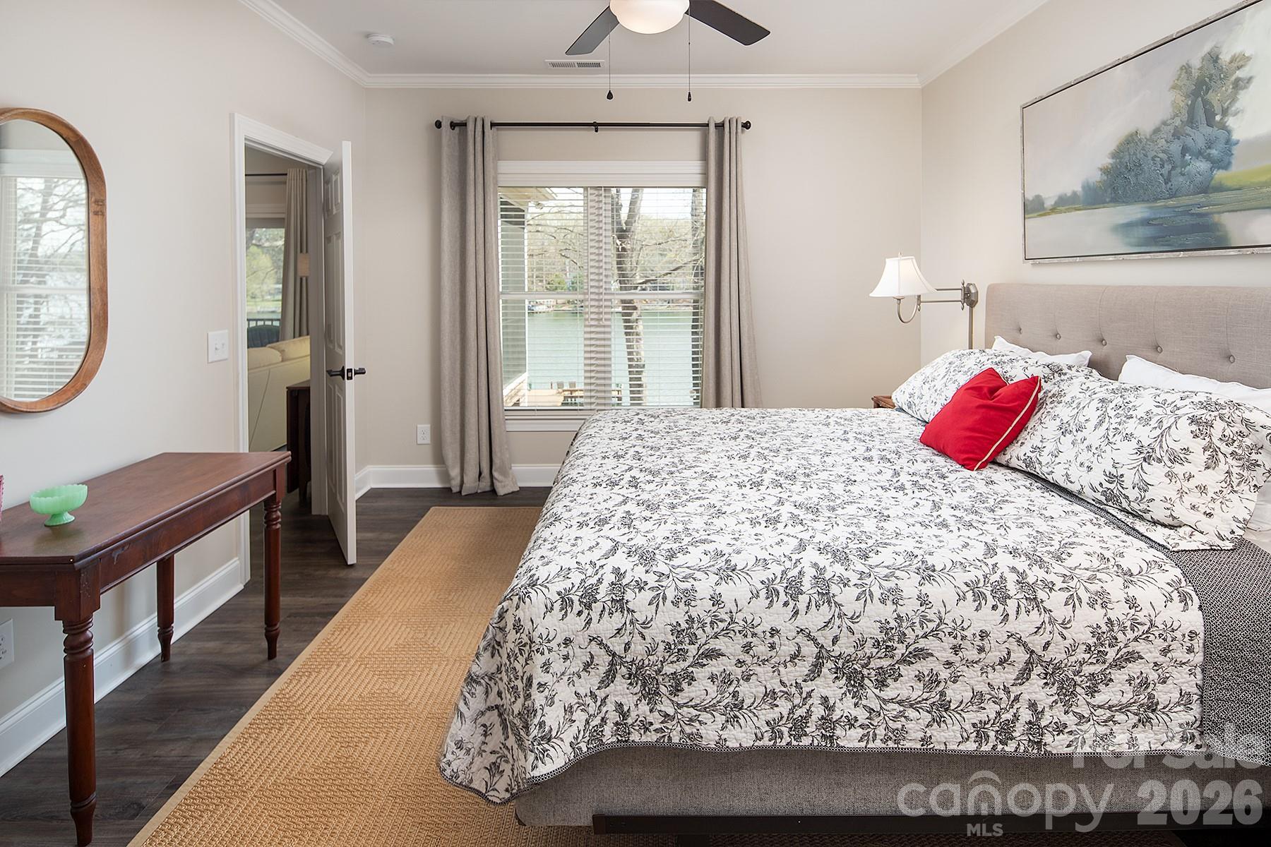 689 Emerald Shores Road Mount Gilead, NC 27306 - Photo 27 of 46 a bedroom with a large bed and a chandelier