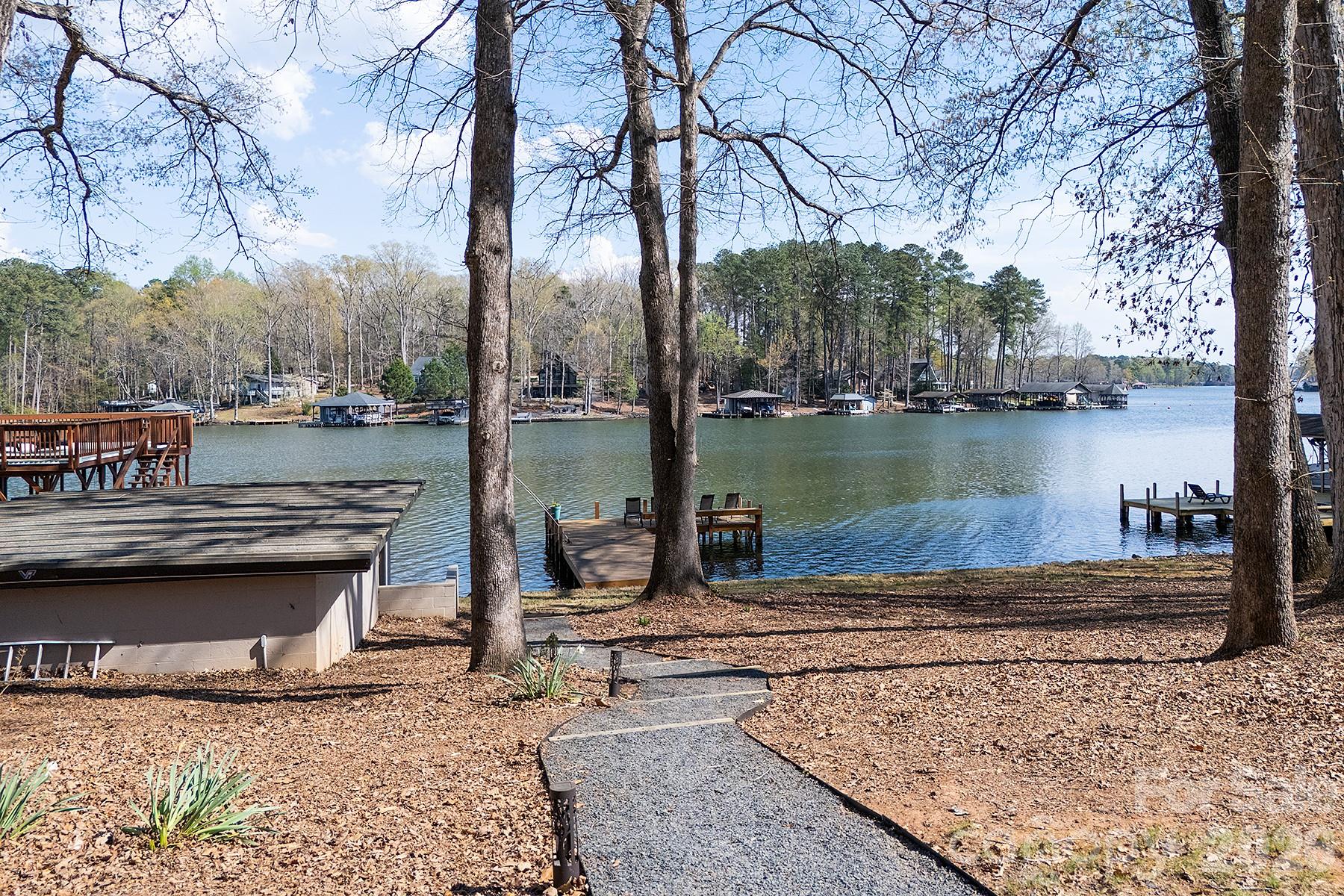 689 Emerald Shores Road Mount Gilead, NC 27306 - Photo 3 of 46 a lake view with a bench next to a lake
