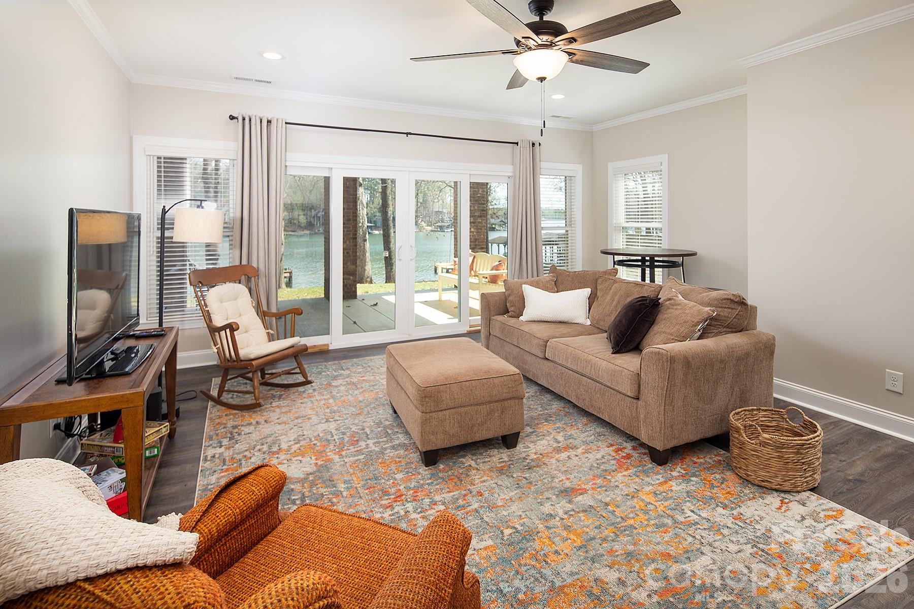 689 Emerald Shores Road Mount Gilead, NC 27306 - Photo 31 of 46 a living room with furniture and a flat screen tv