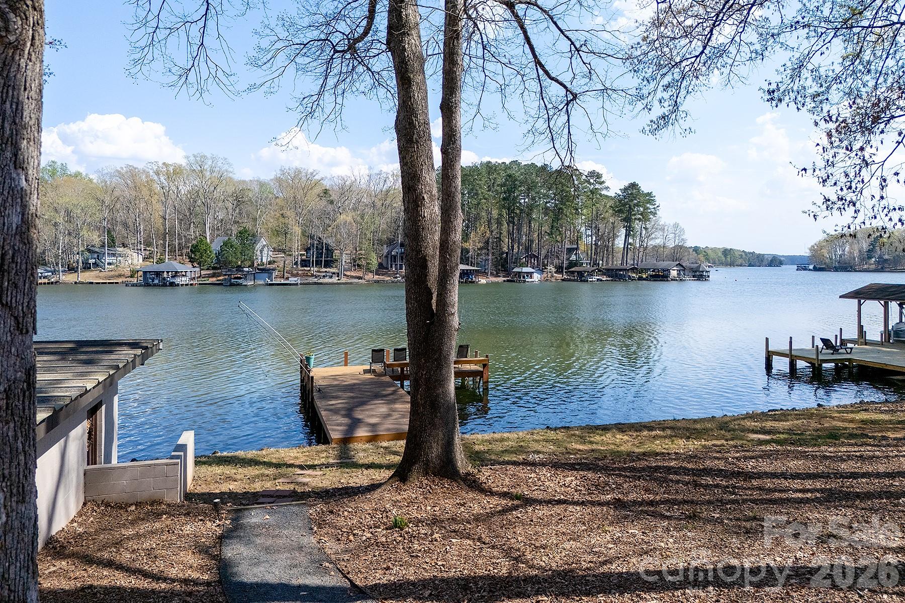 689 Emerald Shores Road Mount Gilead, NC 27306 - Photo 39 of 46 a view of a lake with houses in the back